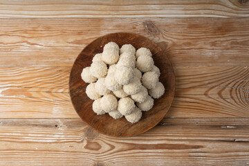 Coconut candies pile, coco ball. White truffle ball, indian ladoo or laddu with sweet cream and coco