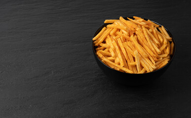 Fried chips sticks, finger potato chips, golden shoestring fries pile, French fries