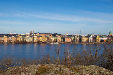 Scenic panoramic view of Stockholm city waterfront on a clear sunny day.
Panoramic view of Stockholm skyline with colorful buildings by the water on a bright clear.