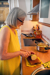 Senior Woman Preparing a Meal in a Bright Modern Kitchen