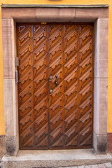 Ornate wooden door with geometric pattern in historic Stockholm building.
Detailed wooden door with...