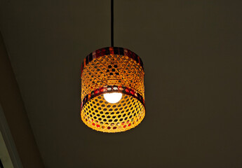 Lighting ceiling hanging lamp with bamboo wicker weave on roof in room