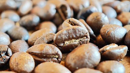 Medium roast coffee beans on a wooden plate