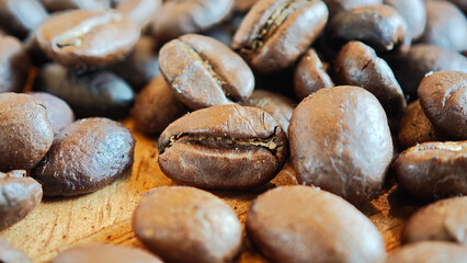 Medium roast coffee beans on a wooden plate