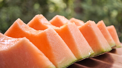 Cantaloupe melon slices on wooden