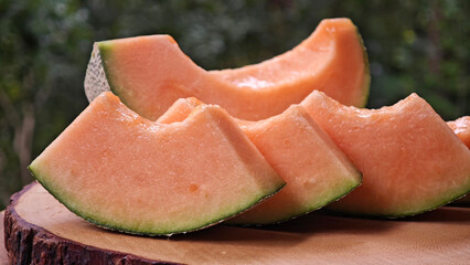 Cantaloupe melon slices on wooden
