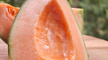Cantaloupe melon slices on wooden