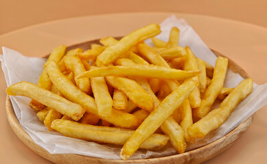 French fries served on a wooden plate