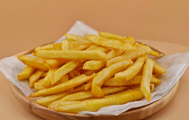 French fries on a wooden plate