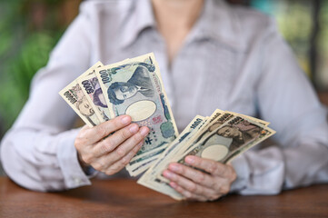 Yen banknotes money on hand. concept of personal loan
,home finance,income,savings.