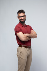 Naklejka premium Smiling Confident Man in Red Polo with Arms Crossed