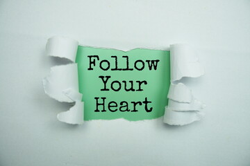 Follow Your Heart message written on green paper with torn paper background