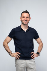 Confident Man with Hands on Hips and Bright Smile