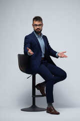 Spanish Man on Stool with Open Arms and Upward Palms in Calm Pose