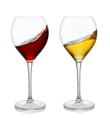 Red and white wine splashing inside the glass isolated on white background with clipping path