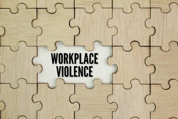 Wooden puzzle with WORKPLACE VIOLENCE. physical violence, harassment, intimidation, or other...