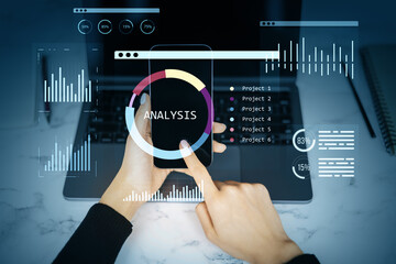 Smartphone displaying digital analysis dashboard with charts, graphs, and infographics over laptop on workspace background in modern style.