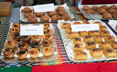 Traditional Portuguese Pastries Displayed on a Table at a Market Stall
