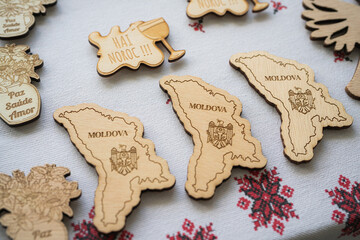 Wooden Moldova Map Souvenirs with Engraved Details Displayed on Traditional Fabric
