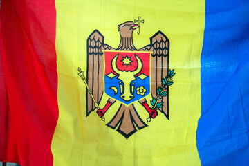 Flag of Moldova Displaying the National Emblem and Vibrant Tricolor Design