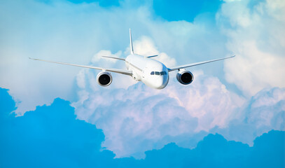 White passenger airplane flying in the sky amazing clouds in the background - Travel by air...