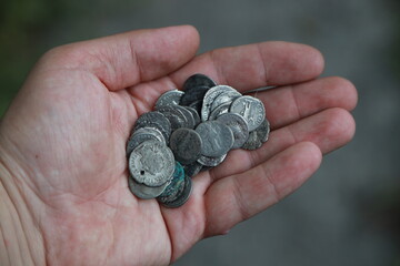 Pile of antique silver coins of ancient Rome in hand
