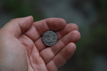 Medieval silver coin one rupee of India in hand