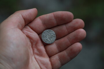 Medieval silver coin one rupee of India in hand