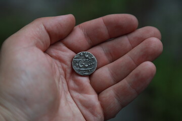 Medieval silver coin one rupee of India in hand