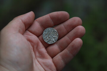 Medieval silver coin one rupee of India in hand