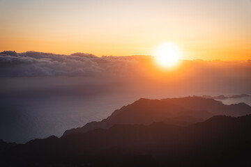 Breathtaking Sunset or Sunrise Over Mountain Peaks and Cloud Sea, Golden Hour Light Illuminating Majestic Landscape and Vast Sky with Copy Space