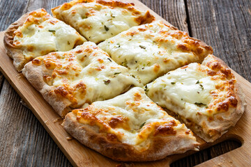 Pinsa bianca white pizza with oregano on wooden table