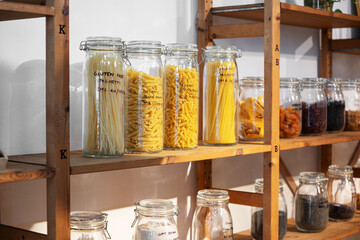 Jars filled with gluten free pasta and dried fruits displayed in an eco-friendly shop