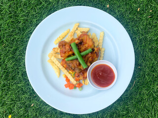 Overhead Shot of Chicken Wings Meal with Fries and Sauce on Plate