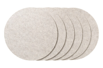 Group of circular felt coasters or placemats arranged in a staggered pattern isolated on...