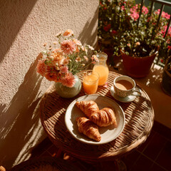 Cozy breakfast with croissants, coffee, orange juice