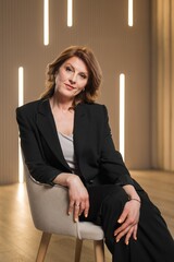 Patriot middle aged woman in black business suit studying confidence and business style