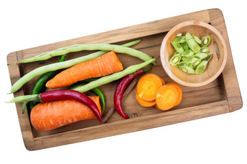 fresh vegetables on a wooden tray with a white isolated background. shot from an overhead view