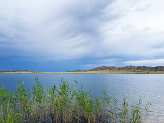 Open Lake with Reeds and Granite Mountains in the Background

