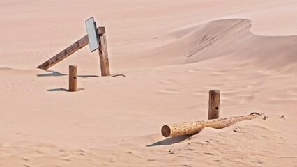 Wooden Signpost Poles and Beams at Abandoned Village Buried under Sand of Desert Dunes