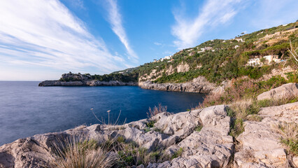 Fototapeta premium Characteristic cliff of Capitan Cook Beach in Massa Lubrense with Capri in the distance. Sorreno coast . Italy