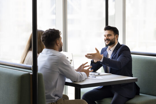 Planning for future. Young couple sit at table with professional legal or financial advisor business consultant realtor discuss loan offer investment opportunities home buying with trusted specialist