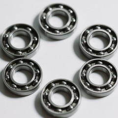 An arrangement of six ball bearings in a circular pattern presents a clean and organized view, highlighting the precision and engineering of these mechanical components .