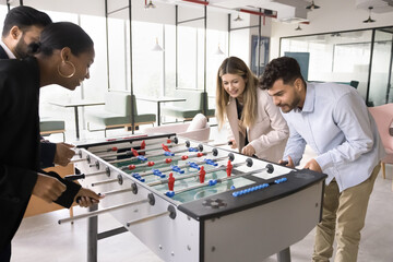 Casual office fun. Joyful enthusiastic multiethnic workmates colleagues engaged in friendly...
