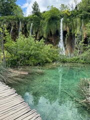 Scenic view of Plitvice Lakes waterfalls and wooden trail in Croatia
A breathtaking aerial view of Plitvice Lakes National Park in Croatia, showcasing turquoise water, lush greenery.