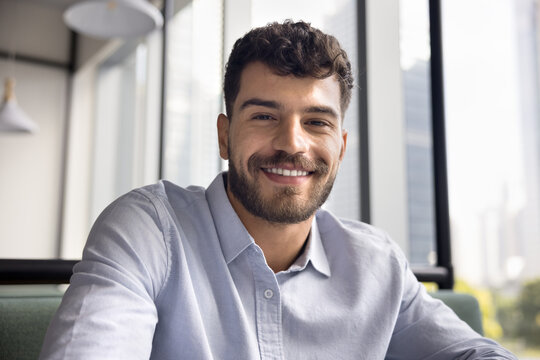 Screen webcam view headshot portrait smiling gen z male vlogger influencer looking at camera broadcast live stream from cafe. Happy young man expert freelancer join business video conference remotely