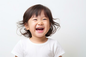 Portrait of cheerful young girl with open mouth, laughing against white background, wearing white t shirt