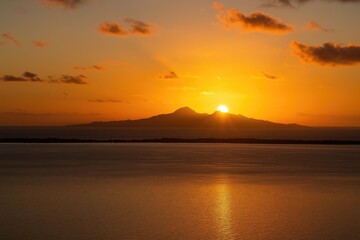 Morning scene of an island and lagoon in the South Pacific as seen from a nearby tropical destination