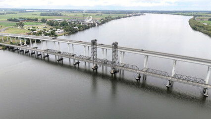 A stunning Aerial View of Pacific Highway Harwood Bridge crosses the Clarence River under a cloudy sky in the Northern Rivers region of New South Wales, Australia 