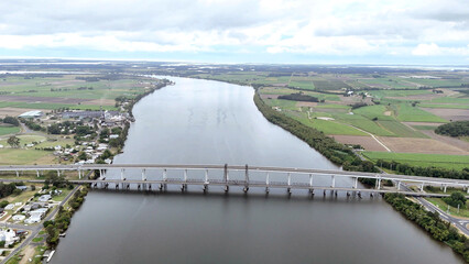 A stunning Aerial View of Pacific Highway Harwood Bridge crosses the Clarence River under a cloudy sky in the Northern Rivers region of New South Wales, Australia 